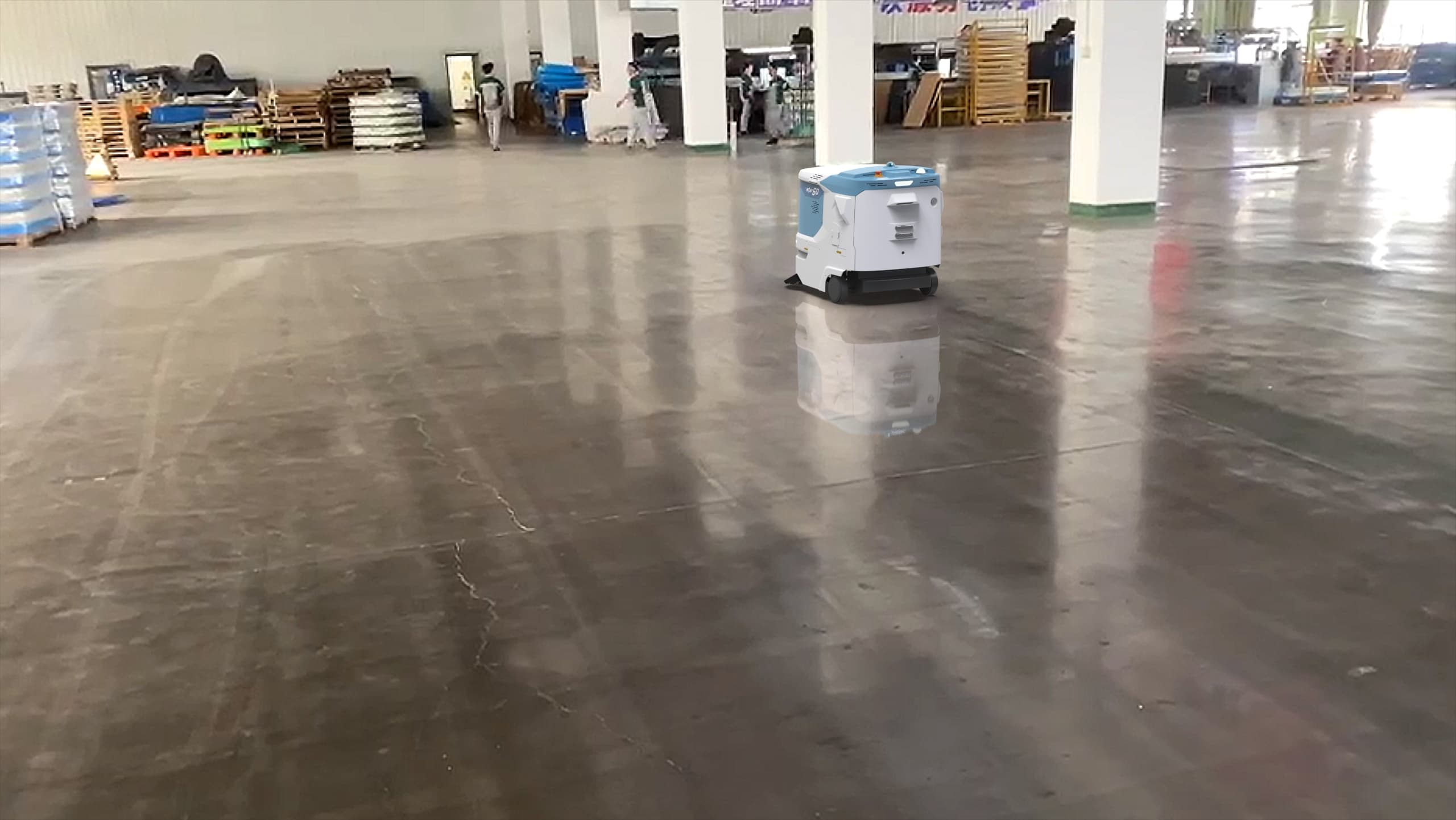 Autonomous commercial floor care robot operating in a large industrial facility