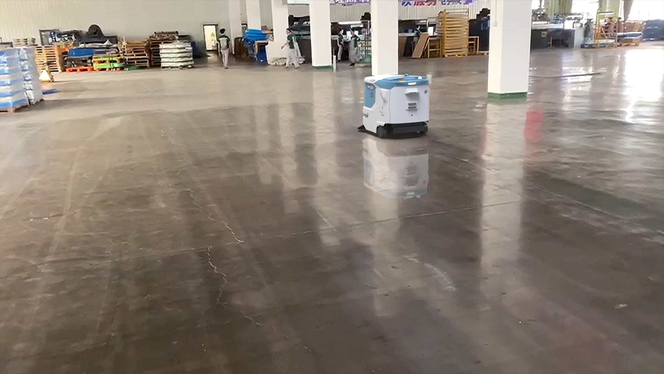 Autonomous commercial floor care robot operating in a large industrial facility